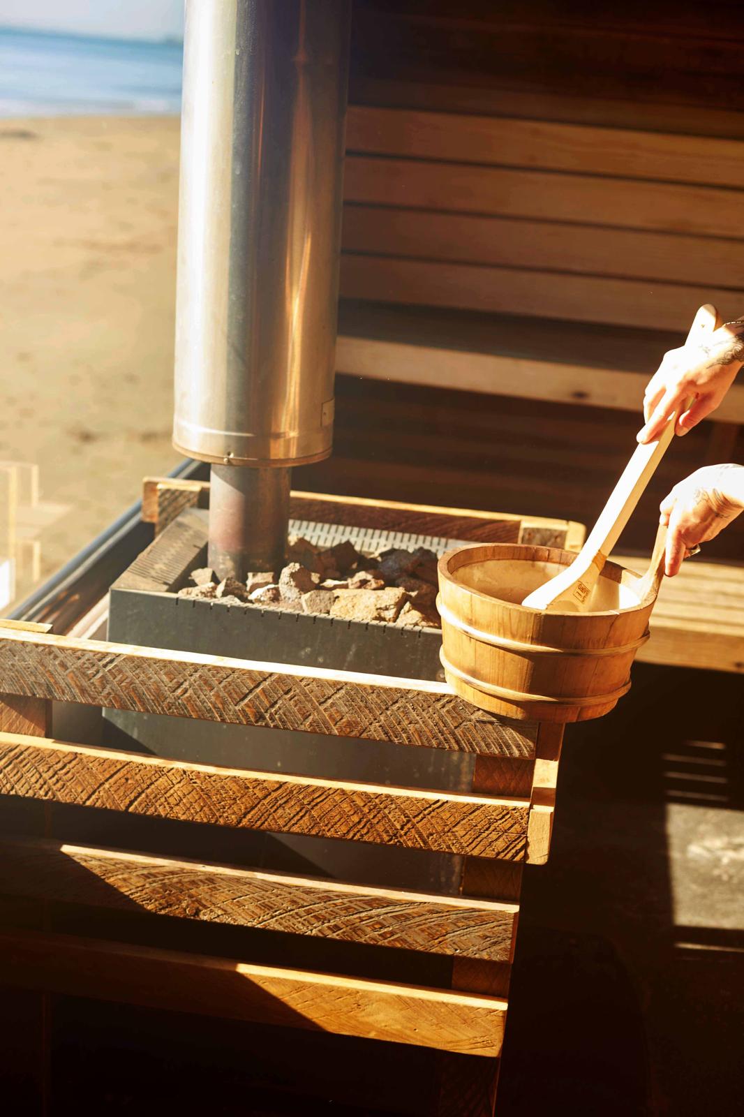 Wood-fired sauna stove with bucket and ladle
